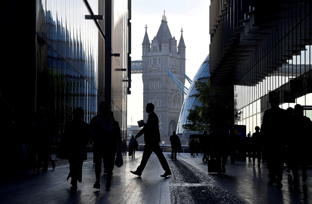 Workers are seen in the More London district, with the Tower Bridge in the background, during the morning rush hour in London, Britain, September 25, 2018. u00e2u20acu201d Reuters pic