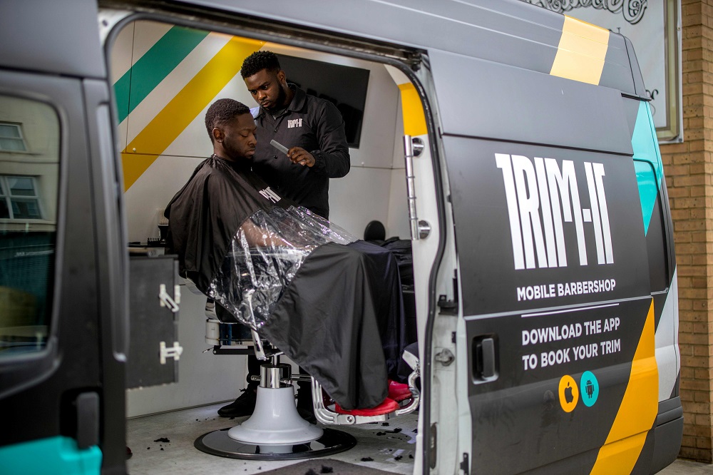 Full-time barber, Kris Roberton trims a client's hair in the customized van of mobile barbershop, Trim-It, on the streets of south London May 17, 2019. u00e2u20acu201d AFP pic           