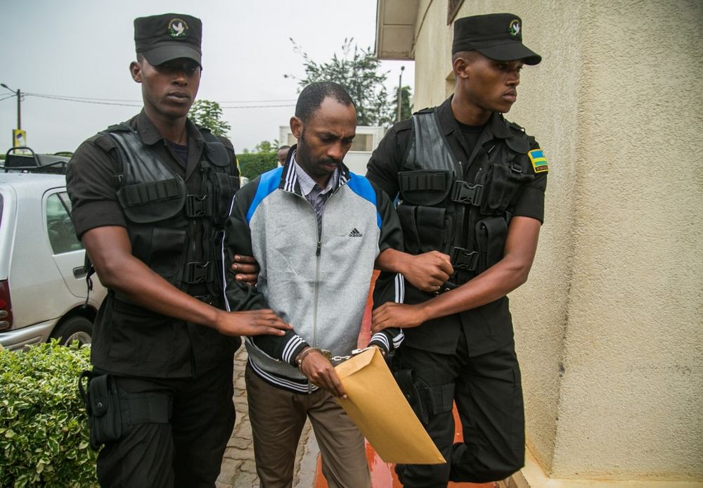 Callixte Nsabimana (centre), spokesman for the National Liberation Front (FLN) armed group, is escorted by police officers at the Gasabo Primary Court in Kigali, Rwanda, May 23, 2019. u00e2u20acu201d AFP pic
