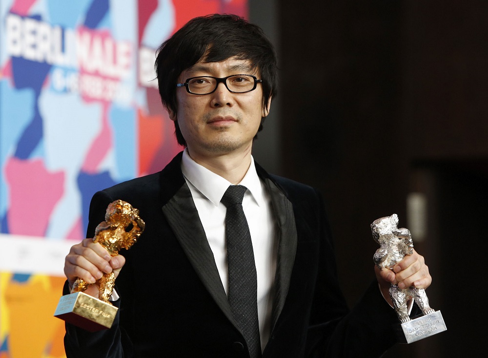 In this file photo taken on February 15, 2014, Chinese director Diao Yinan poses with the Golden Bear for Best Film and the Silver Bear for Best Actor trophies at the 64th Berlinale Film Festival in Berlin.  u00e2u20acu201d AFP pic       