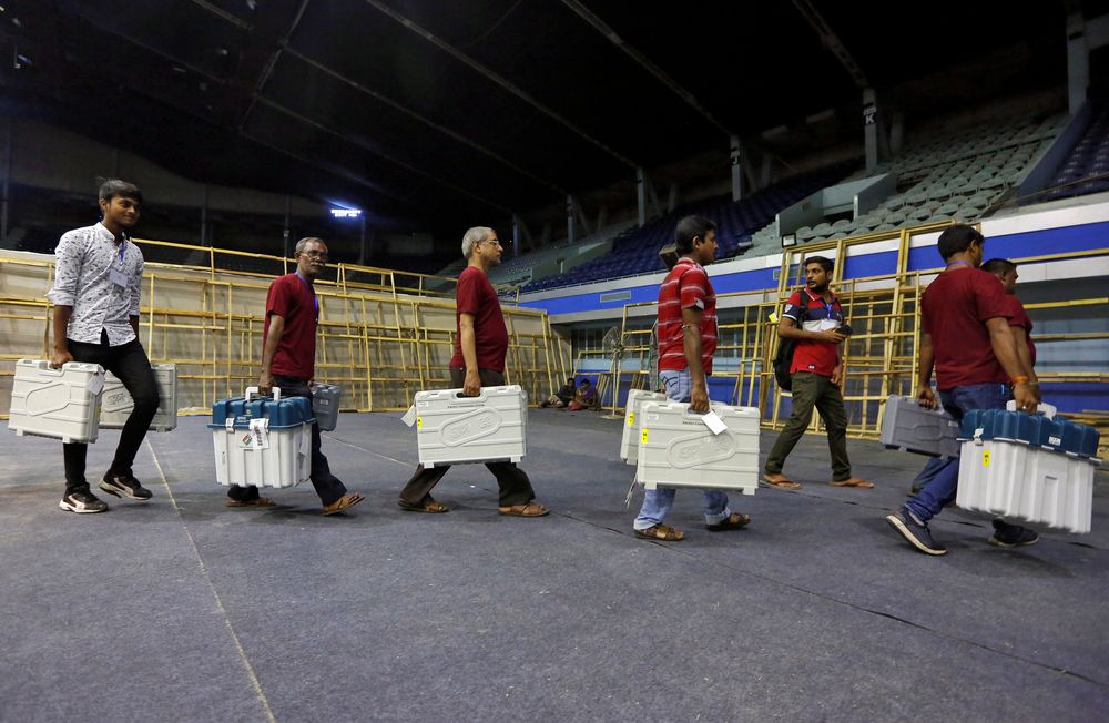Members of election staff carry Electronic Voting Machines (EVM) and Voter Verifiable Paper Audit Trail (VVPAT) machines after collecting them from a distribution centre at an indoor stadium, in Kolkata, India, May 18, 2019. u00e2u20acu201d Reuters pic