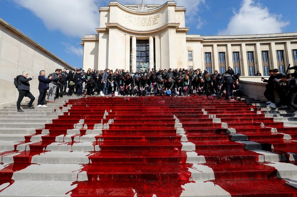 Members of the action group Extinction Rebellion (XR) spill fake blood on the steps of the Trocadero esplanade during a demonstration to alert on the state of decline of biodiversity, on May 12, 2019 in Paris. u00e2u20acu201d AFP pic