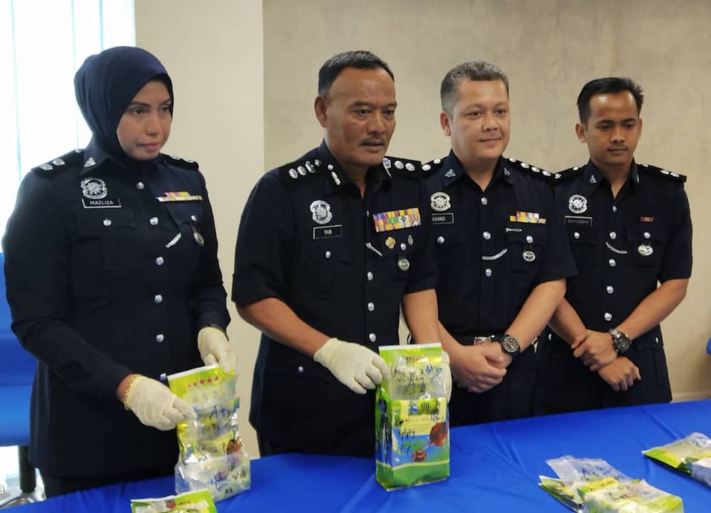 Johor Baru North police chief Assistant Commissioner Mohd Taib Ahmad with the seized syabu during a press conference at the Johor Baru North district police headquarters in Skudai, Johor Baru here today. u00e2u20acu201d Picture by Ben Tan