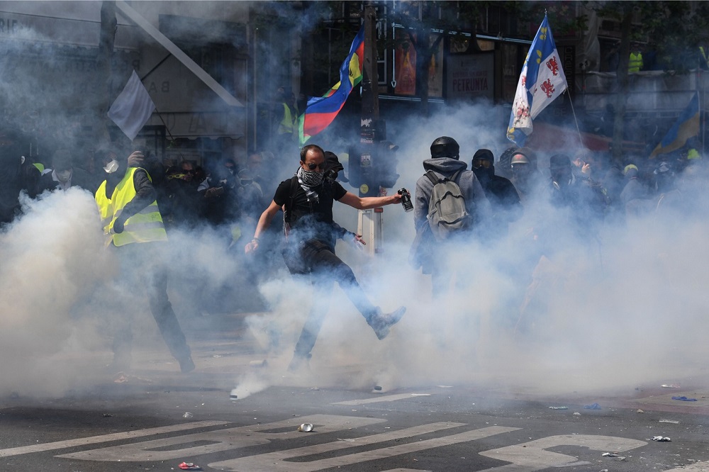 A protestor kicks back a tear gas canister during clashes with police prior to the start of the annual May Day rally in Paris May 1, 2019. u00e2u20acu201d AFP pic