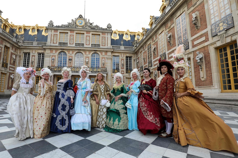 Guests in baroque period costumes pose for a picture at the Chateau de Versailles u00e2u20acu02dcFetes Galantesu00e2u20acu2122 masked ball in Versailles, just south west of the French capital Paris May 27, 2019. u00e2u20acu201d AFP pic