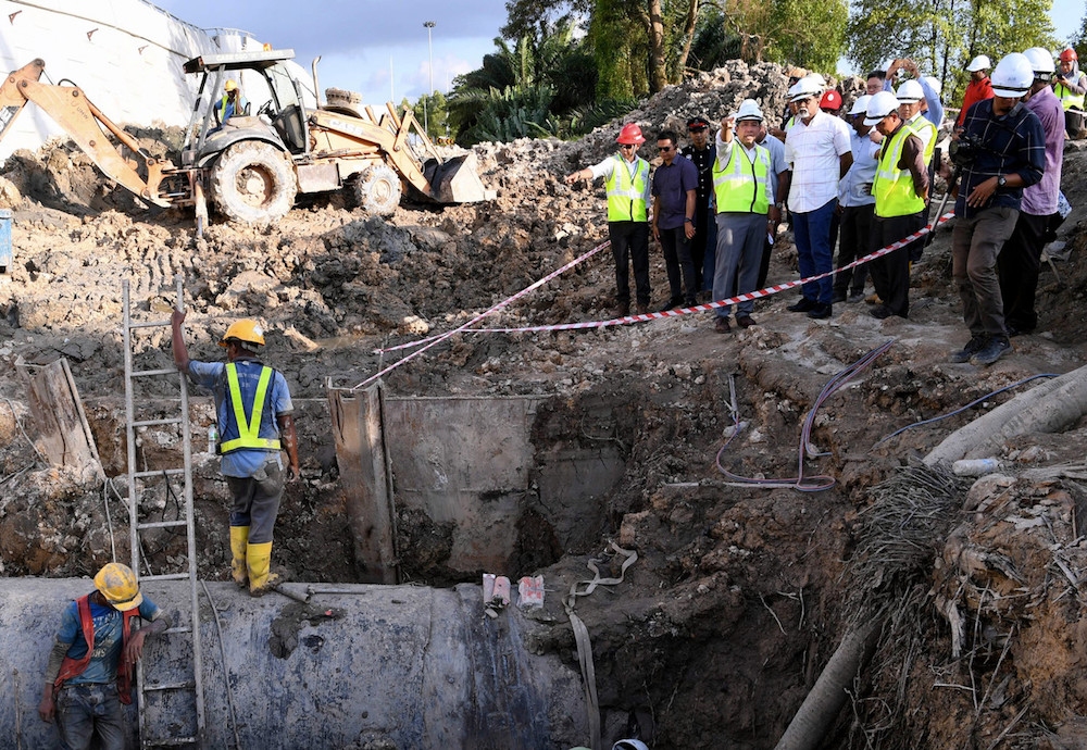 Water, Land and Natural Resource Minister Dr Xavier Jayakumar visits the site of the burst water mains at the West Coast Expressway project site in Klang May 7, 2019. u00e2u20acu201d Bernama pic
