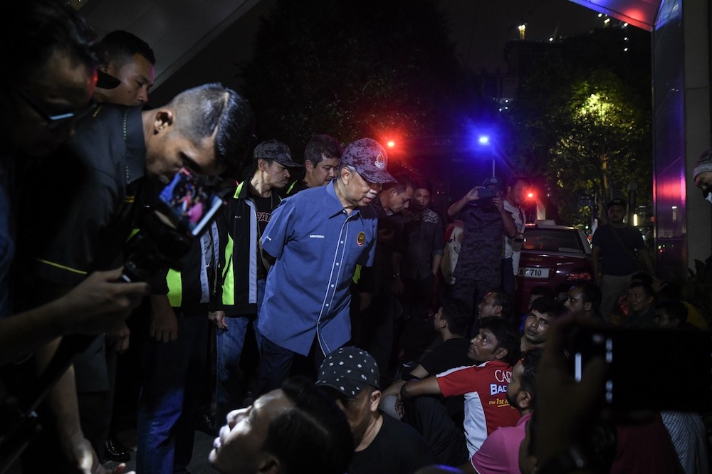 Home Minister Tan Sri Muhyiddin Yassin speaks to some of the illegal immigrants detained in an Immigration Department raid in Kampung Baru, Kuala Lumpur May 28, 2019. u00e2u20acu201d Bernama pic