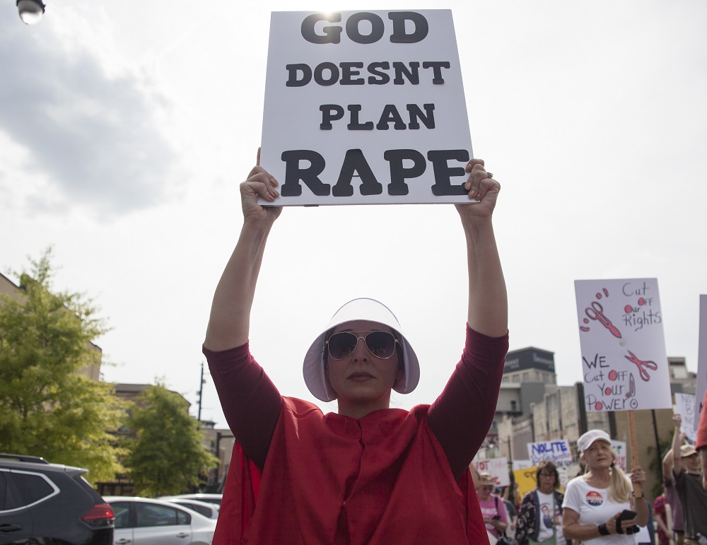 Pro-choice protester dressed as a character television series u00e2u20acu02dcHandmaidu00e2u20acu2122s Taleu00e2u20acu2122 holds a sign during the March For Reproductive Freedom outside the State capital building in Montgomery, Alabama May 19, 2019. u00e2u20acu201d AFP pic          