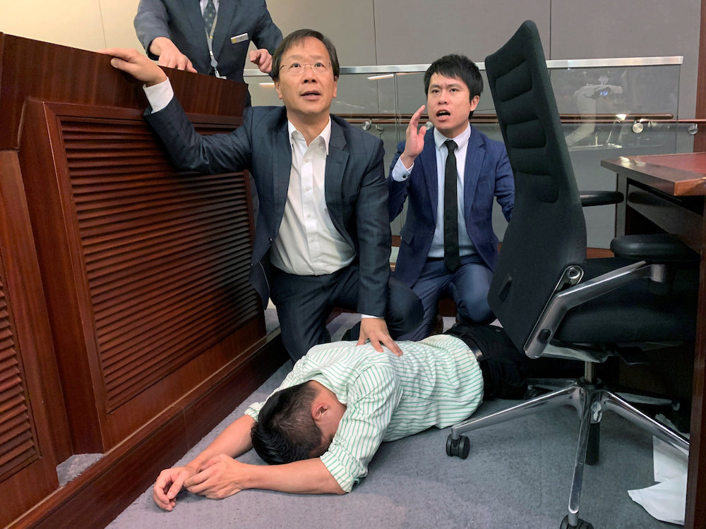 Pro-democracy lawmaker Gary Fan lies down after clashes with pro-Beijing lawmakers during a meeting for control of a meeting room to consider the controversial extradition bill, in Hong Kong, China May 11, 2019. u00e2u20acu201d Reuters picnn