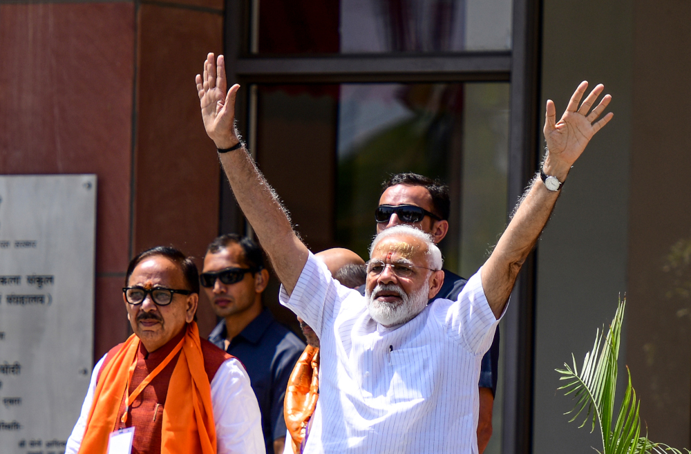 Indian Prime Minister Narendra Modi waves to supporters at the Trade Facilitation Centre and Crafts Museum after offering prayers at the famous Kashi Vishwanath temple, in Varanasi May 27, 2019. u00e2u20acu201d AFP pic 
