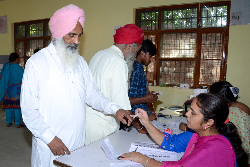 An Indian election official marks the finger of a voter as he prepares to cast his ballot at a polling station on the outskirts of Amritsar May 19, 2019, during the seventh and final phase of Indiau00e2u20acu2122s general election. u00e2u20acu201d AFP pic