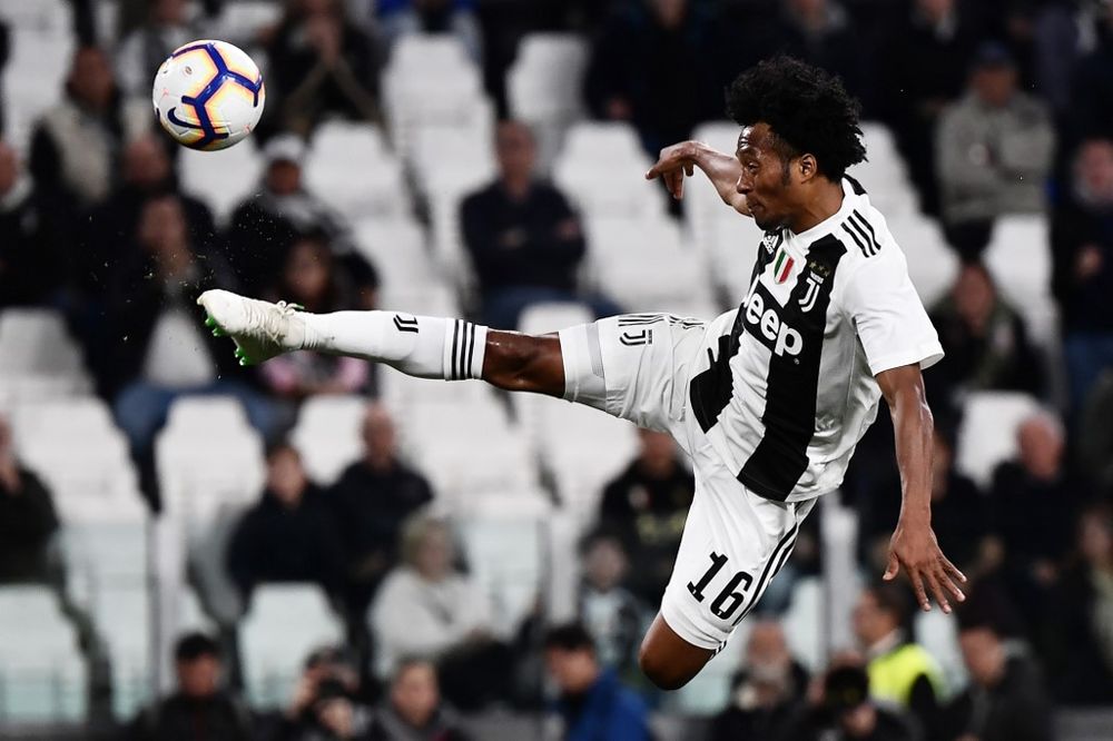 Juventusu00e2u20acu2122 Colombian midfielder Juan Cuadrado jumps for the ball during the Italian Serie A match between Juventus and Torino on May 3, 2019, at the Allianz Stadium in Turin. u00e2u20acu201d AFP pic