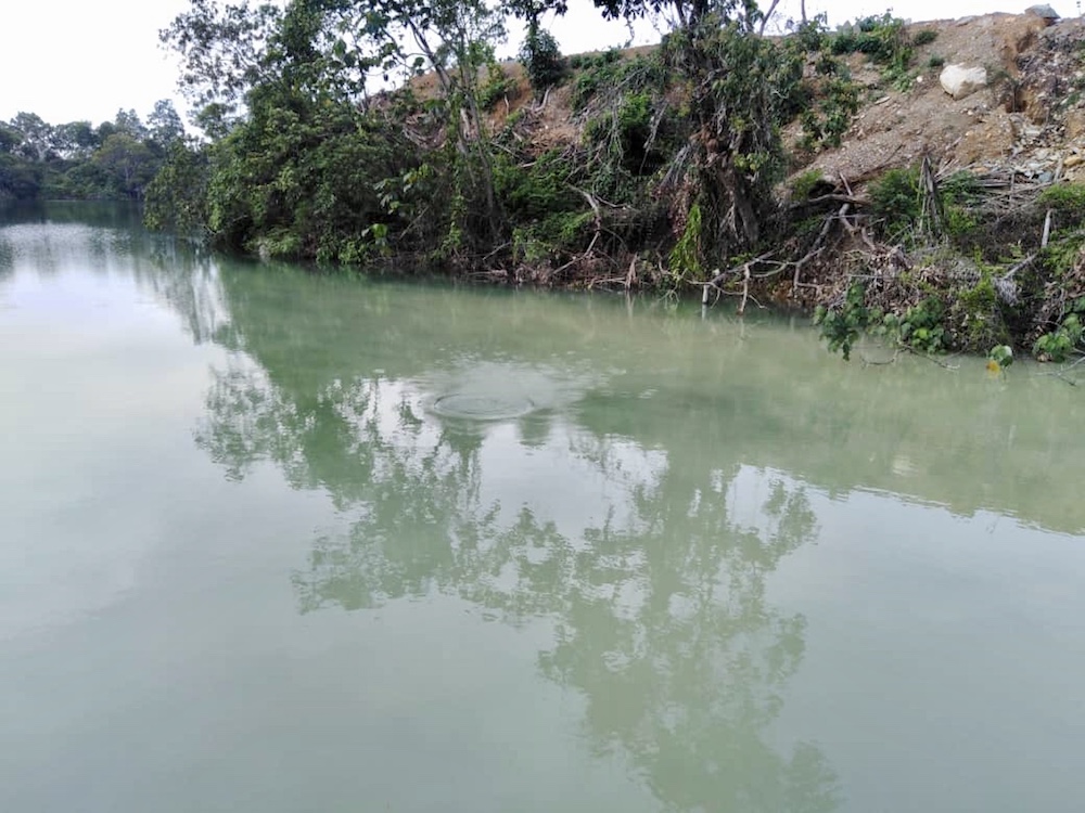 The disused quarry pool in Kuari Felda Ayer Hitam in Kluang where 13-year-old Aniq Imran Yusof drowned. u00e2u20acu201d Picture courtesy of the Johor Fire and Rescue Department