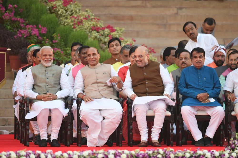 Narendra Modi (left) looks on as he sits next to Bharatiya Janata Party President Amit Shah (second right) before Modi's swearing-in ceremony as Indian Prime Minister at the President house in New Delhi on May 30, 2019. u00e2u20acu201d AFP pic