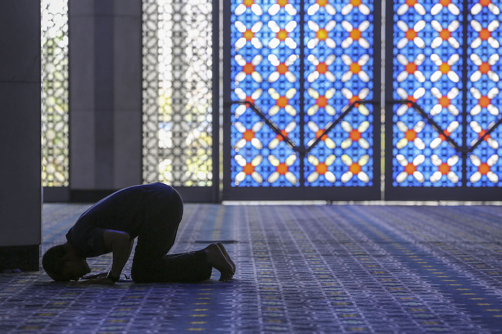 The silhouette of a man as he prays during the holy month of Ramadan at the Sultan Salahuddin Abdul Aziz Shah Mosque in Shah Alam, May 18, 2019. u00e2u20acu201d Yusof Mat Isann