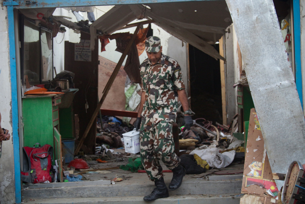 A Nepali security personnel inspects a blast site in Kathmandu May 26, 2019. u00e2u20acu201d AFP pic