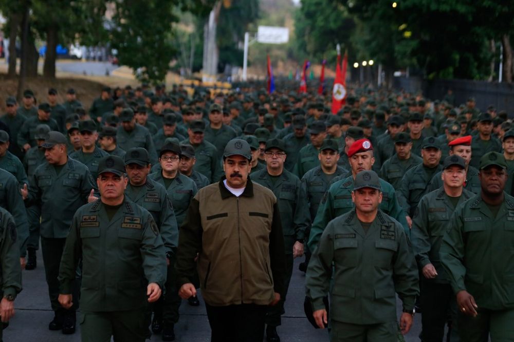 Venezuelau00e2u20acu2122s President Nicolas Maduro (centre) waving military troops accompanied by Defence Minister Vladimir Padrino (left) at the u00e2u20acu02dcFuerte Tiunau00e2u20acu2122 in Caracas, Venezuela on May 2, 2019. u00e2u20acu201d Miraflores Palace press office / AFP pic