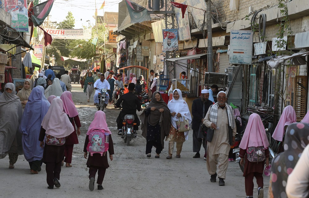 In this picture taken on May 3, 2019, Pakistani Shiah Hazara minority Muslims walk along a road in Hazara town, a neighbourhood in Quetta. u00e2u20acu201d AFP pic       