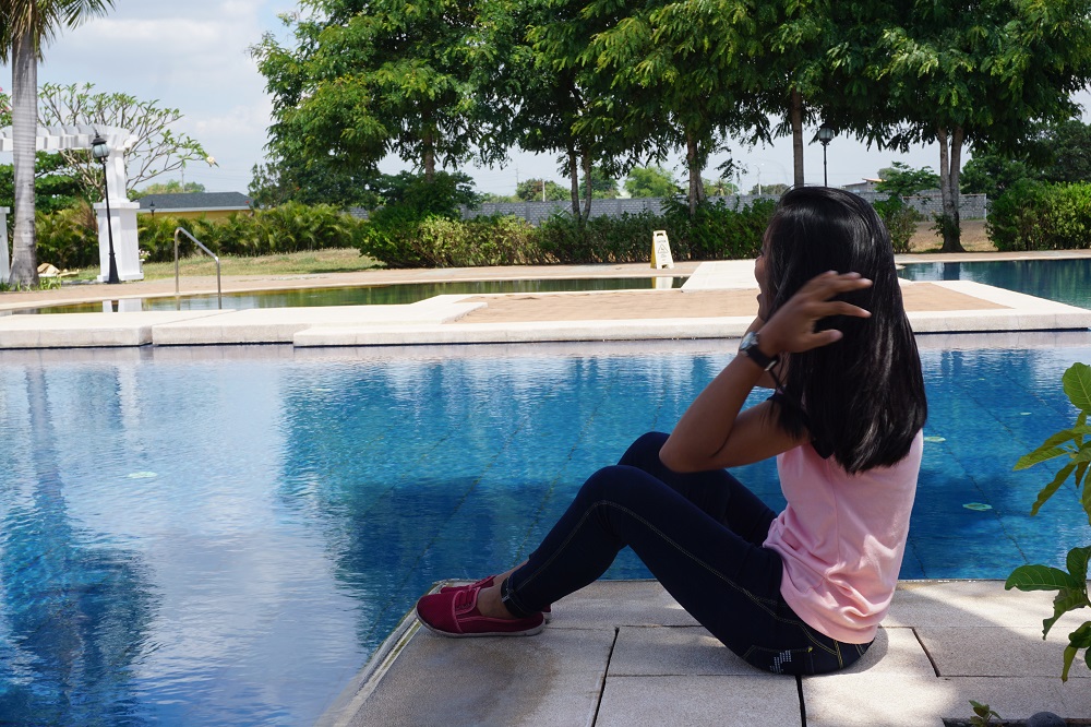Chang, a young survivor of online child sex abuse, looks out over the pool at a private residence in Pampanga Philippines April 5, 2019. u00e2u20acu201d Thomson Reuters Foundation pic