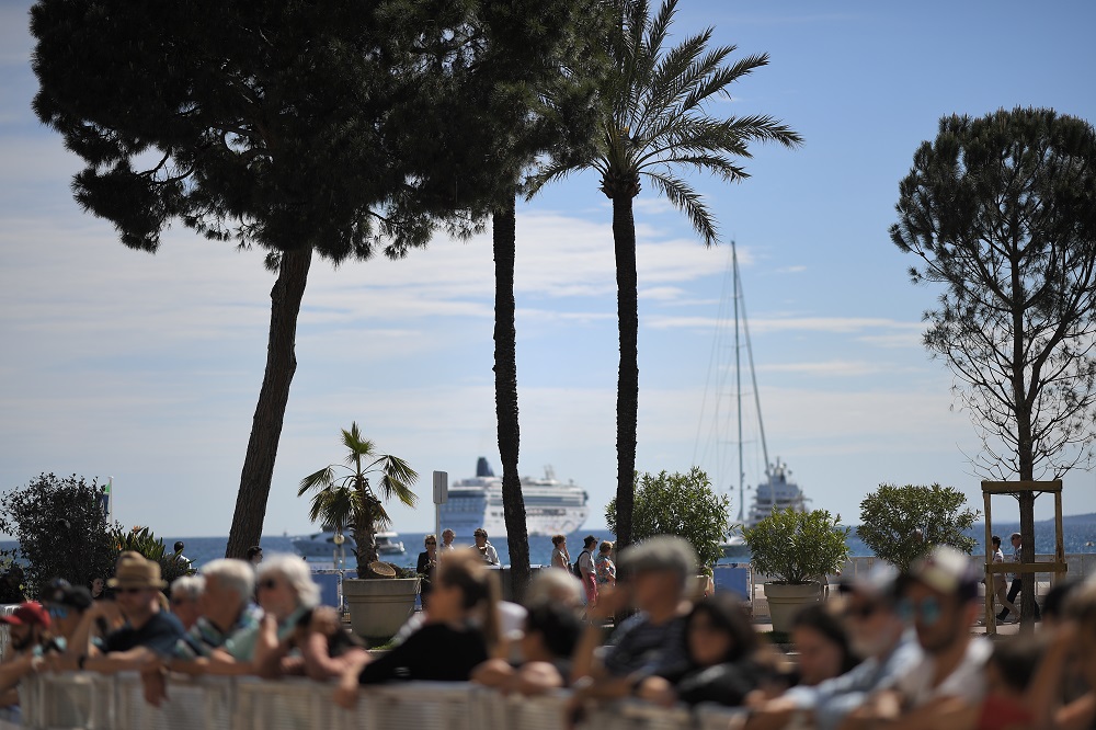 People wait near the Palais des Festivals, 13 May 2019, on the eve of the opening of the 72nd Cannes Film Festival in Cannes, southeastern France. u00e2u20acu201d AFP pic