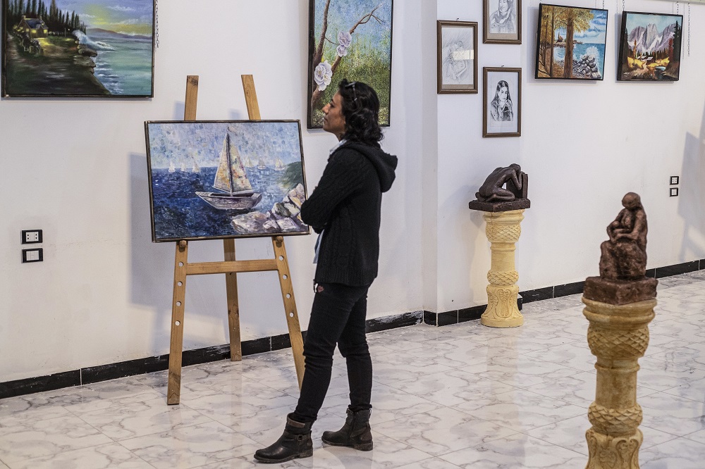 Amal al-Attar, a 37-year-old artist, looks at her artworks on display during an exhibition at the first cultural centre to open since the Islamic State groupu00e2u20acu2122s rule ended in the eastern Syrian city of Raqa May 1, 2019. u00e2u20acu201d AFP pic