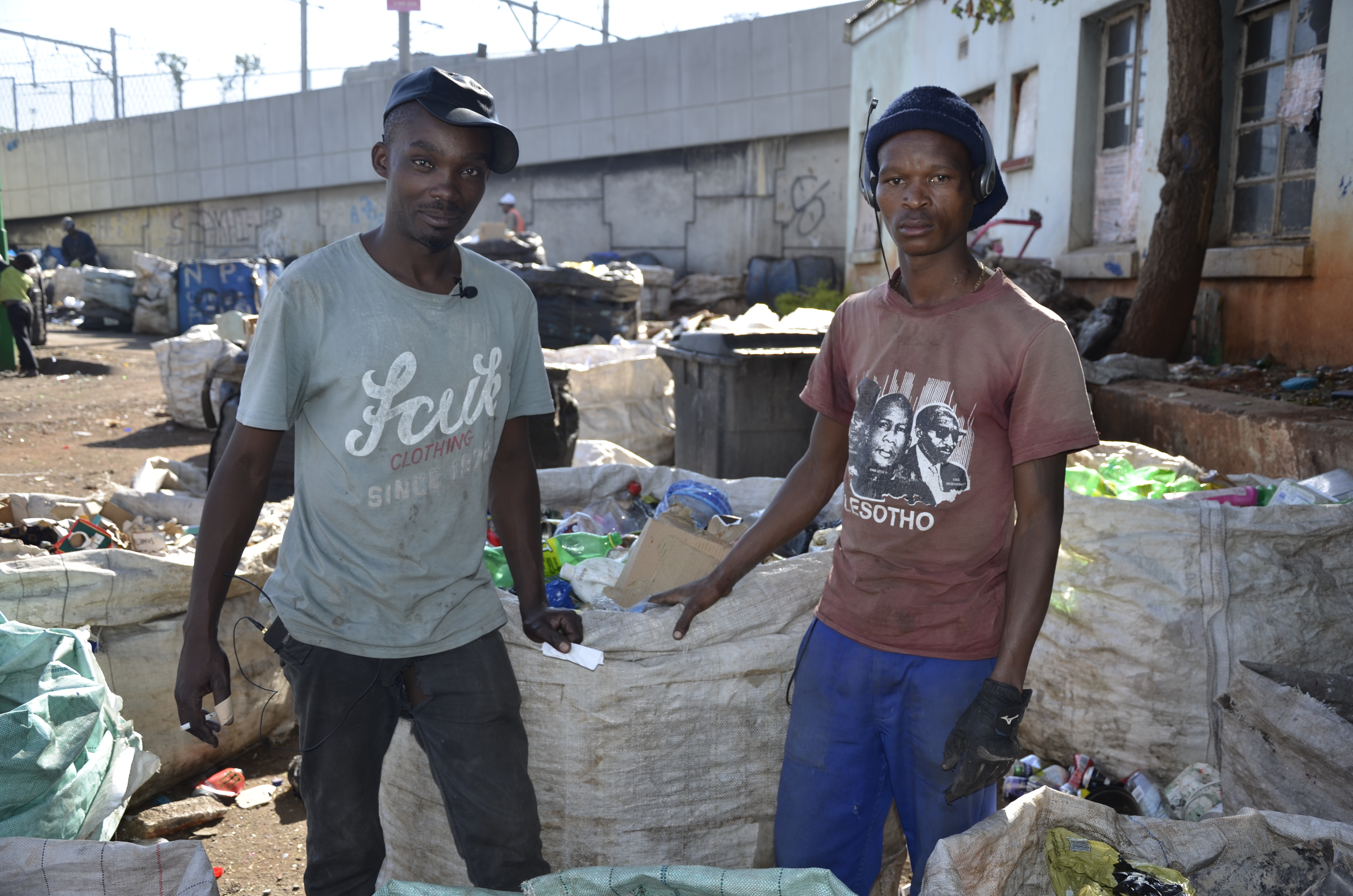 Waste reclaimer Luyanda Hlatshwayo poses with a fellow reclaimer in an abandoned school where over 300 reclaimers sort recycled goods every day, 15 May 2019. u00e2u20acu201d Thomson Reuters Foundation pic
