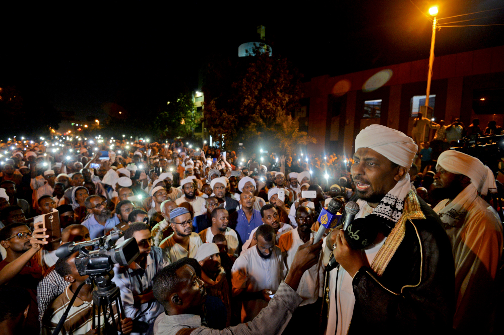 Sudanese hardline cleric Mohamed Ali Jazuli speaks as supporters of Islamist movements rally in front of the Presidential Palace in downtown Khartoum May 18, 2019. u00e2u20acu201d AFP pic 