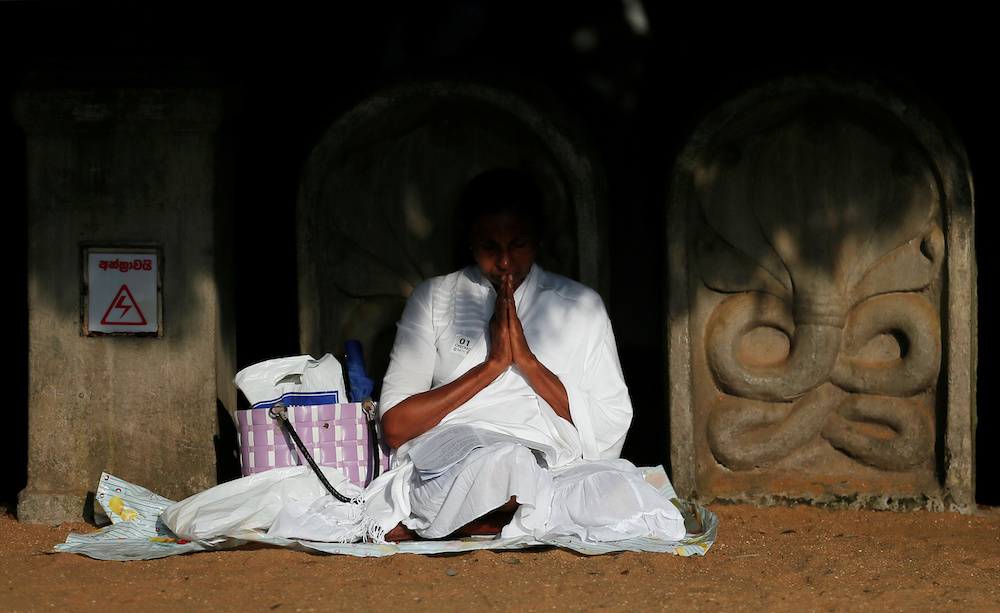 A Buddhist devotee worships at the Kelaniya Buddhist temple during Vesak Day, commemorating the birth, enlightenment and death of Buddha, in Colombo, Sri Lanka May 18, 2019. u00e2u20acu201d Reuters picnn