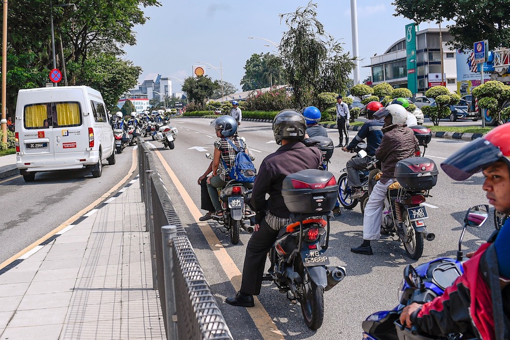 A hearse carrying Sultan Ahmad Shah’s body is escorted by police outriders as it leaves the National Heart Institute in Kuala Lumpur May 22, 2019. — Picture by Hari Anggara