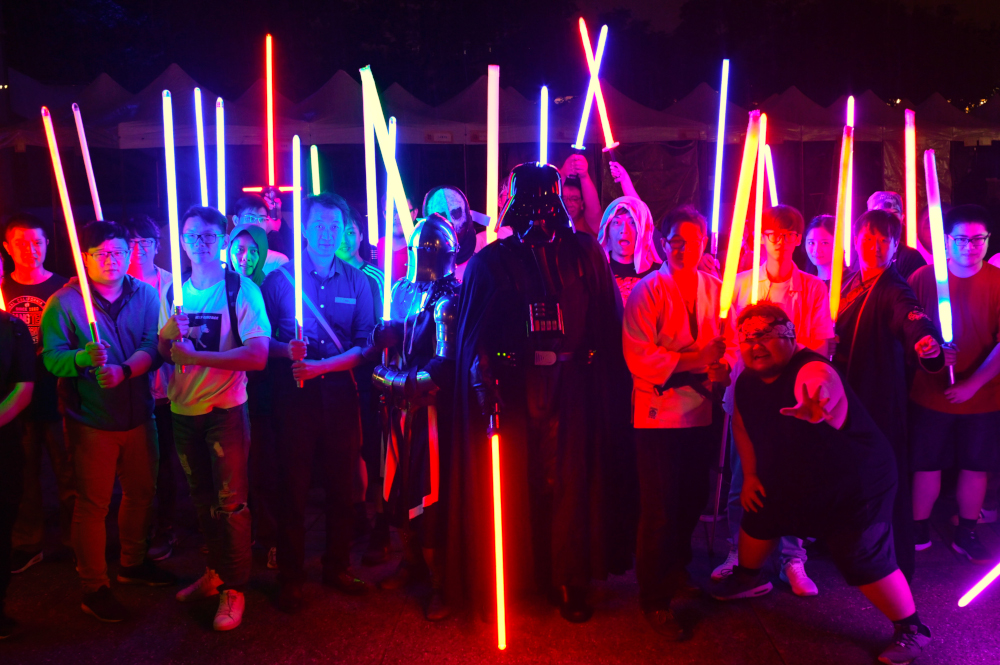 This picture taken April 20, 2019 shows fans posing for photographs with model lightsabers during an event to promote the upcoming unofficial Star Wars Day in Taipei. u00e2u20acu201d AFP pic 