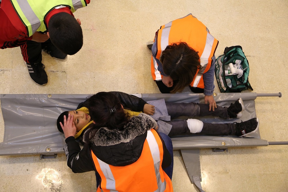 Volunteers conduct a first-aid check on a student during a safety drill at ATakmiliyat Al Kobba 2nd School in Tripoli, Lebanon March 28, 2019. u00e2u20acu2022 Thomson Reuters Foundation pic