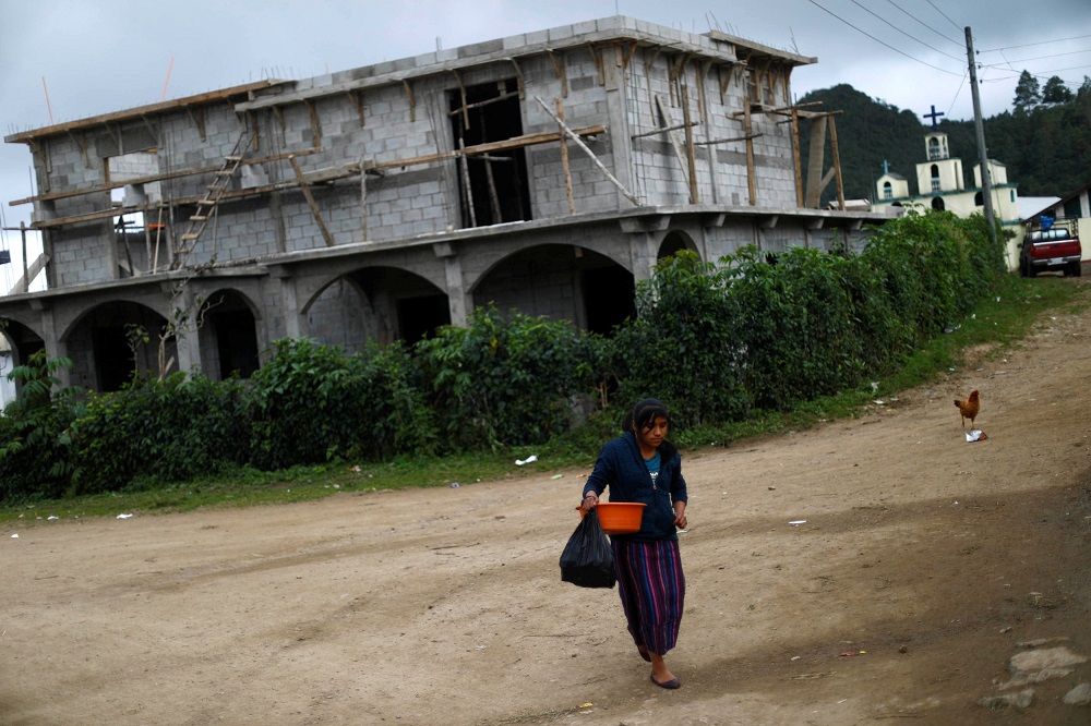 A woman walks in front of a house in the village of Yalambojoch, Guatemala January 26, 2019. u00e2u20acu201d Reuters pic        