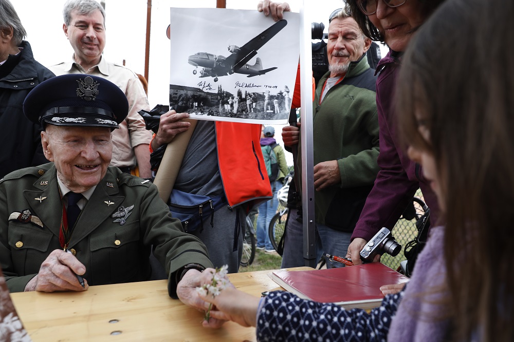 Former Berlin Airlift pilot Gail Halvorsen from the US receives flowers from a girl during a ceremony at the Tempelhofer Feld, a former airfield in Berlin, on May 11, 2019. u00e2u20acu201d AFP pic
