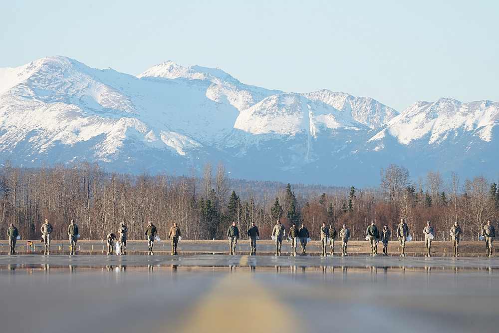 US Air Force airmen search for debris that could damage aircraft on the flight line at Joint Base Elmendorf-Richardson, Alaska April 26, 2019. u00e2u20acu201d US Air Force/Dana Rosso handout via Reuters