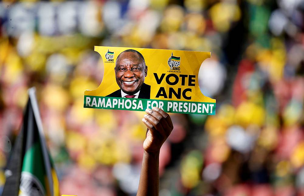 A supporter holds a placard with the face of President of South Africa's governing African National Congress Cyril Ramaphosa at Ellis Park Stadium in Johannesburg May 5, 2019. u00e2u20acu201d Reuters pic