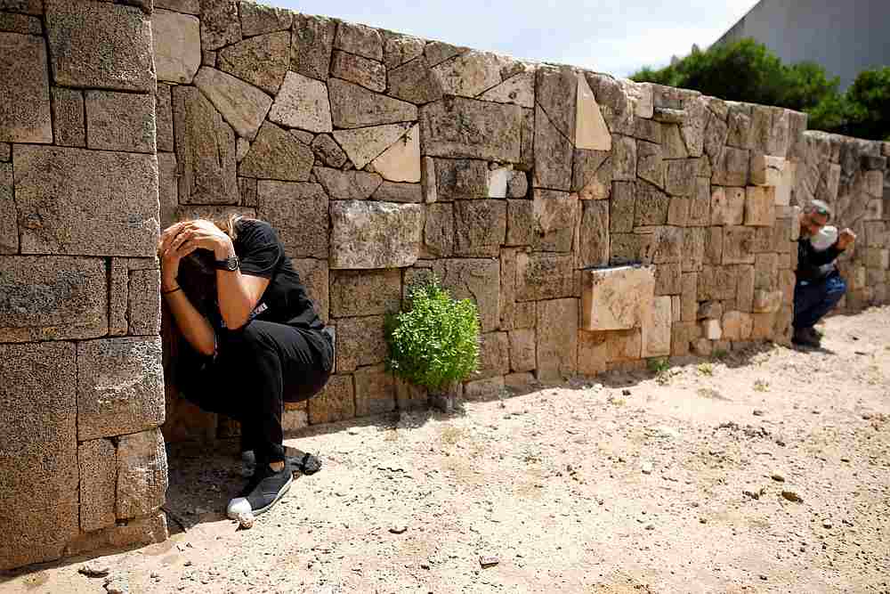 Israelis take cover as a siren sounds warning of incoming rockets from Gaza, during cross-border hostilities, in the southern Israeli city of Ashkelon May 5, 2019. u00e2u20acu201d Reuters pic
