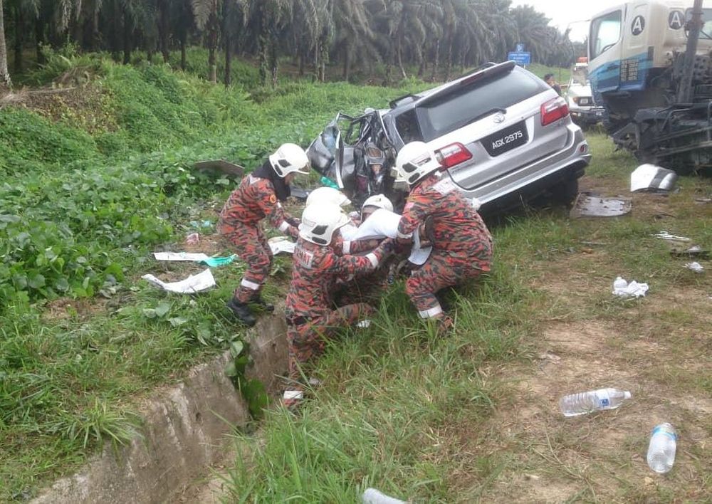 Rescue workers help accident victims from the badly damaged sports utility vehicle May 29, 2019. u00e2u20acu201d Picture courtesy of Bintulu Bomba