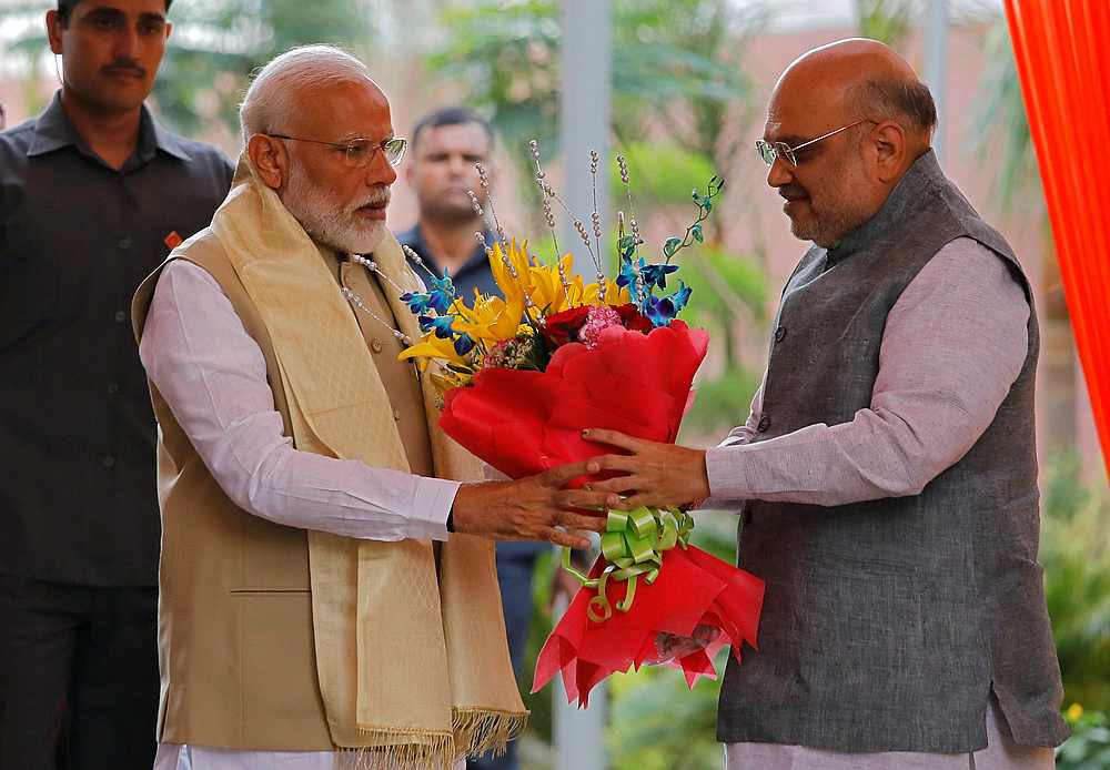 India's Prime Minister Narendra Modi (left) receives a flower bouquet from the Bharatiya Janata Party (BJP) president Amit Shah at the party headquarters in New Delhi May 21, 2019. u00e2u20acu201d Reuters pic