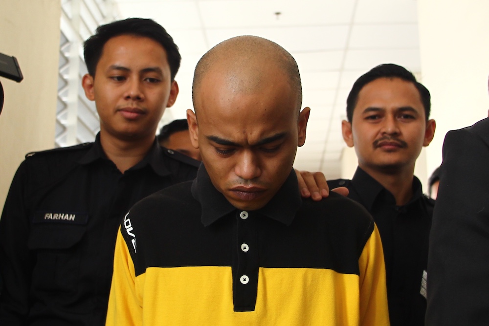 Danial Abdullah Tan is led away from the Kuala Lumpur Magistrateu00e2u20acu2122s Court May 31, 2019, after he pled guilty to smashing a car windscreen in a road rage incident in Seri Kembangan. 