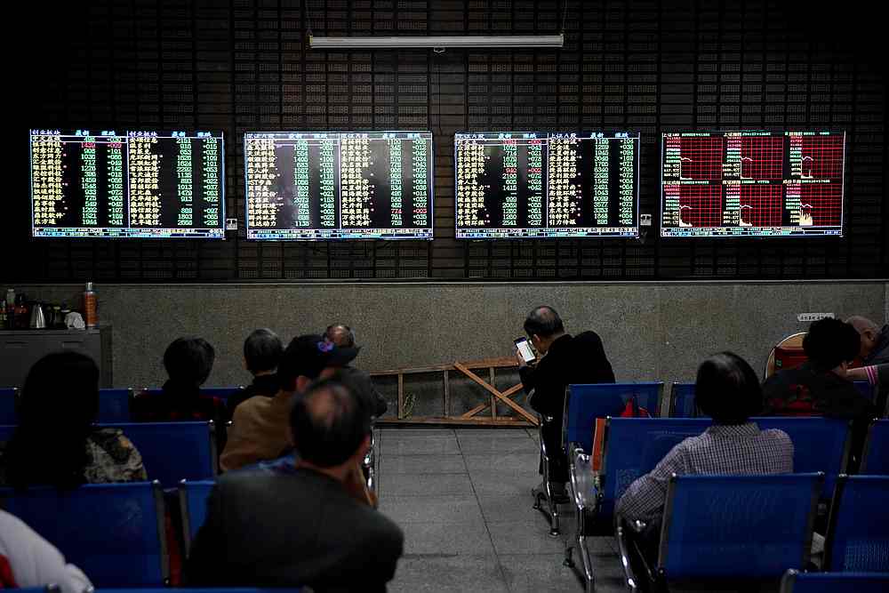 Investors look at screens showing stock information at a brokerage house in Shanghai, China May 6, 2019. u00e2u20acu201d Reuters pic
