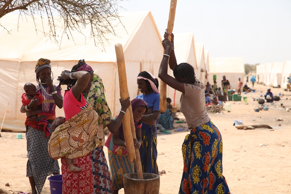 Women pound millet at a camp for internally displaced persons in Barsalogho, Burkina Faso March 3, 2019. u00e2u20acu201d Thomson Reuters Foundation pic