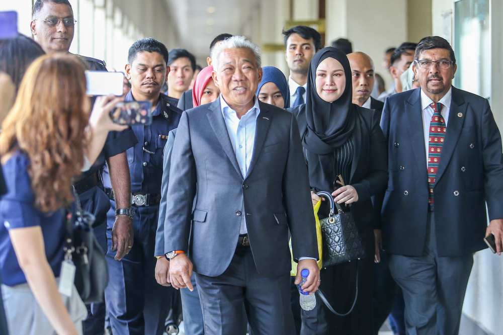 Umno MP Datuk Seri Bung Moktar Radin (left) and wife Datin Seri Zizie Izette A. Samad leave the courtroom after their hearing, May 3, 2019. u00e2u20acu2022 Picture by Hari Anggara