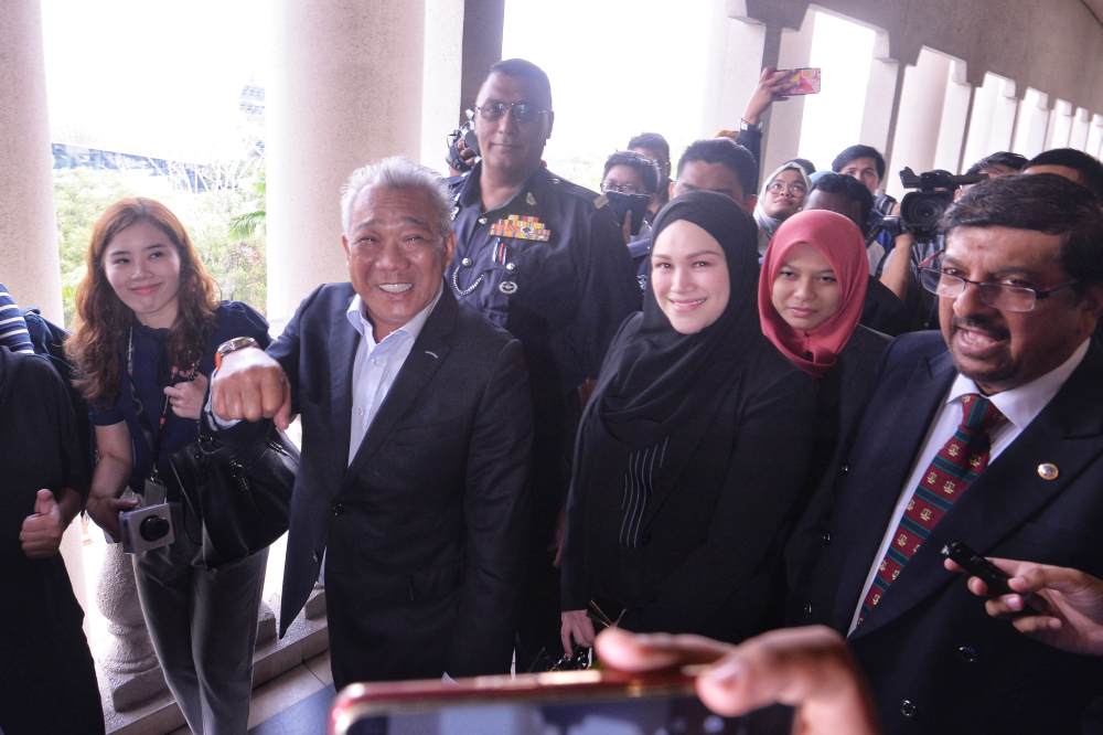 Umno MP Datuk Seri Bung Moktar Radin (left) and wife Datin Seri Zizie Izette A. Samad leave the KL Courts Complex after their hearing, May 3, 2019. u00e2u20acu2022 Picture by Shafwan Zaidon