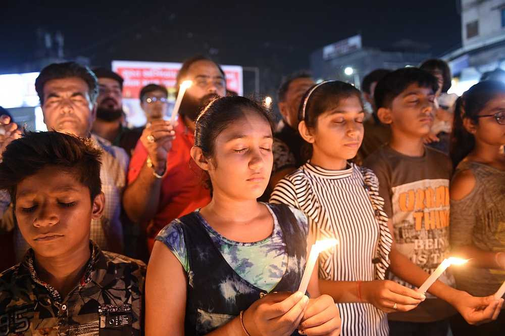Members of a Narendra Modi fan club hold a candlelight vigil to pay homage to the victims of yesterday's fire in a building housing a college in Surat, Ahmedabad May 25, 2019.  u00e2u20acu201d  AFP pic