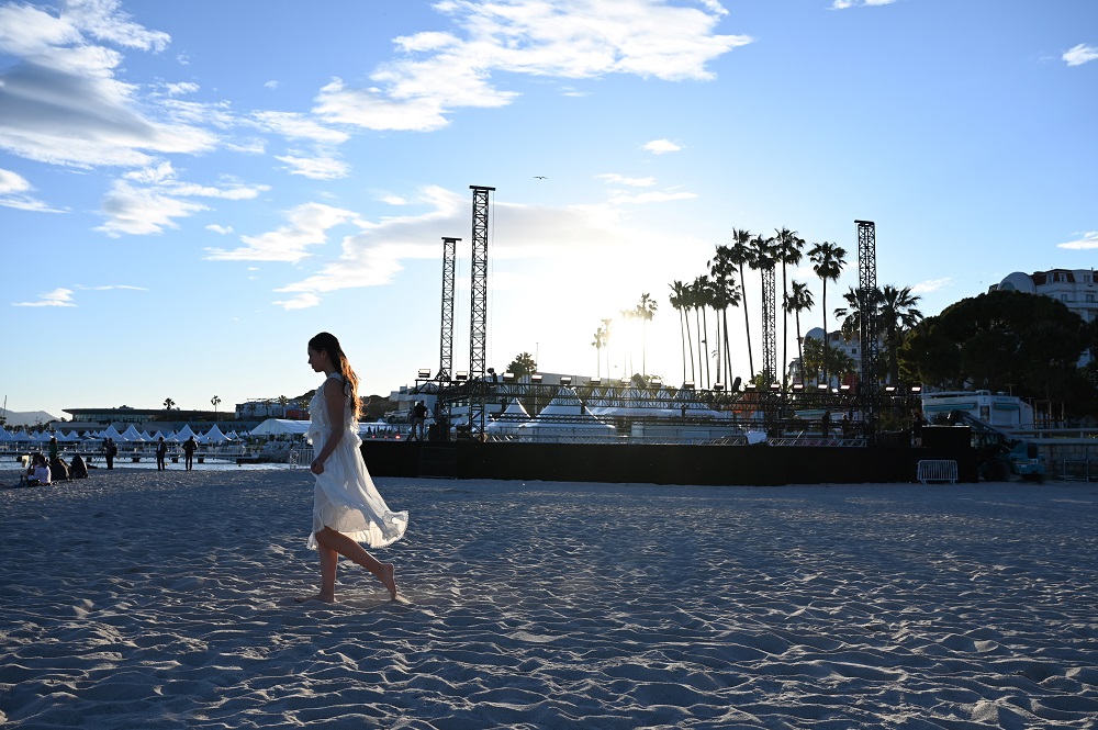 A woman walks on the beach on May 13, 2019 on the eve of the opening of the 72nd edition of the Cannes Film Festival in Cannes, southern France. u00e2u20acu201d AFP pic