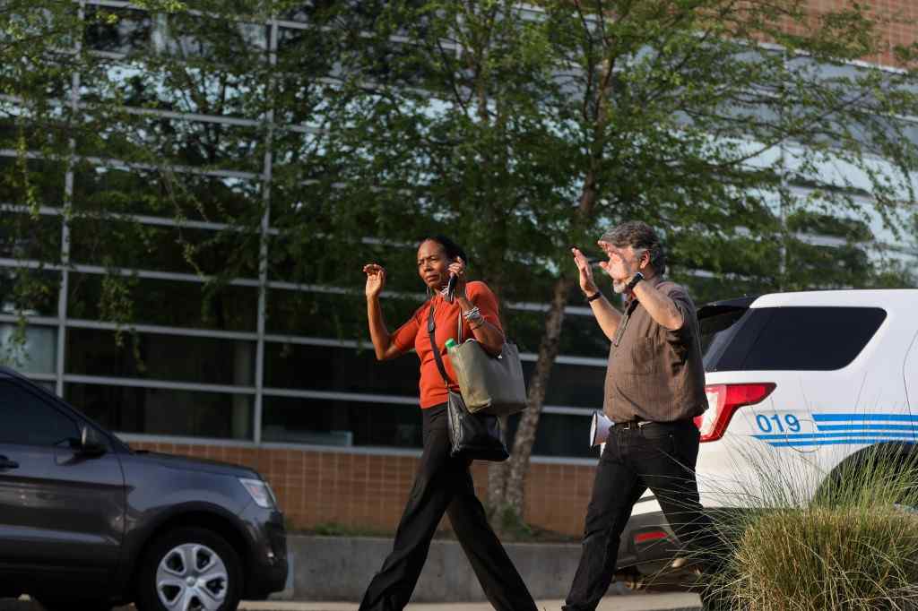 Students and faculty file out of buildings with their hands up during a lockdown after a shooting on the campus of University of North Carolina Charlotte April 30, 2019. u00e2u20acu201d AFP pic