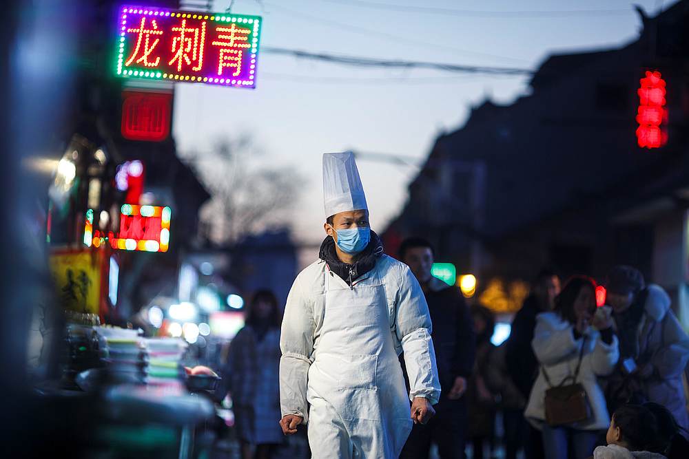 A chef walks outside a restaurant at night in the old town of Luoyang, Henan province, China January 21, 2019. u00e2u20acu201d Reuters pic