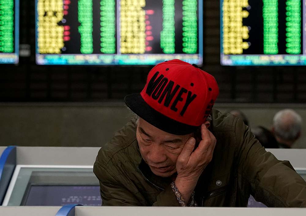 An investor looks at computer screens showing stock information at a brokerage house in Shanghai May 6, 2019. u00e2u20acu201d Reuters pic