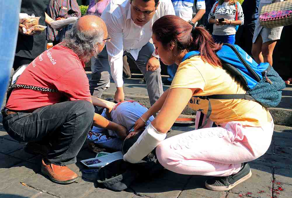 People help a man lying on the ground after being shot by a gunman during a street vendors protest, in Cuernavaca near Mexico City May 8, 2019. u00e2u20acu201d Reuters pic