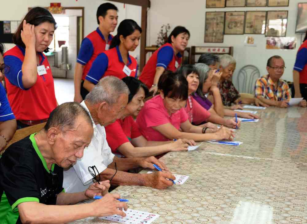 Residents engage in a fun game of Bingo as part of the visit. — Picture courtesy of Da Ma Cai
